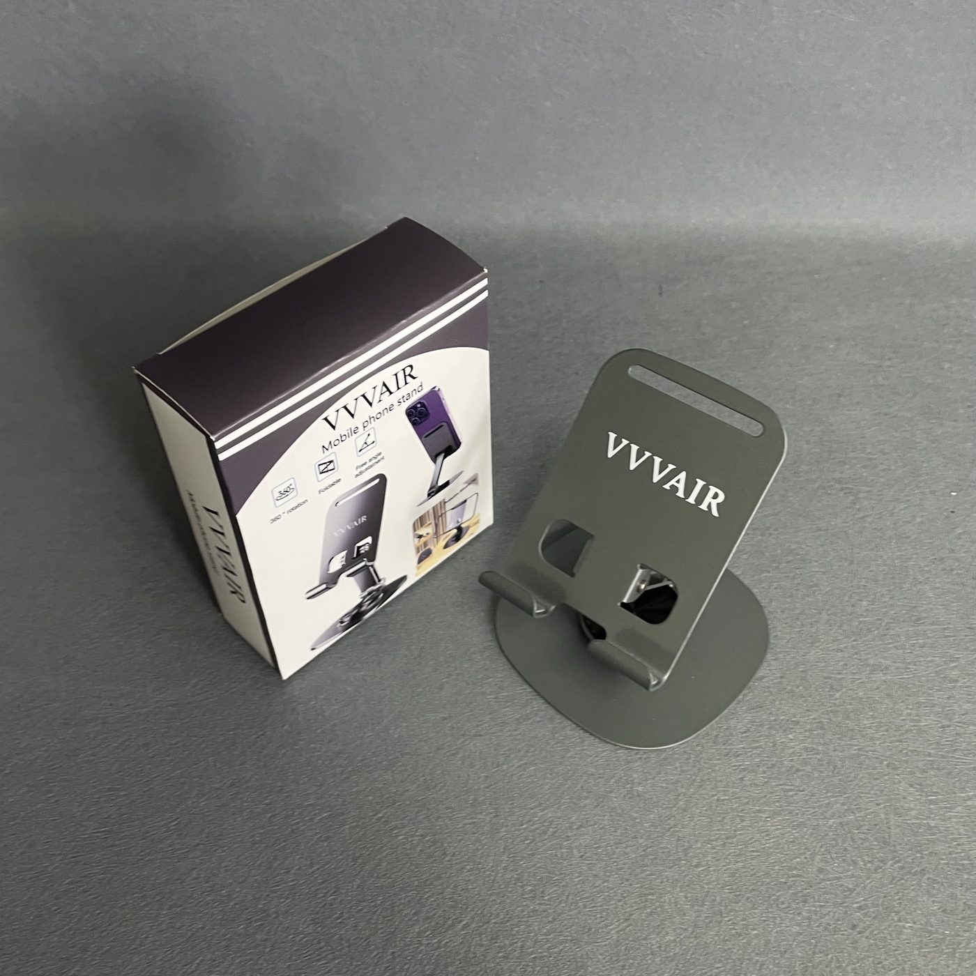 The printed box standing upright beside the assembled Space Gray stand