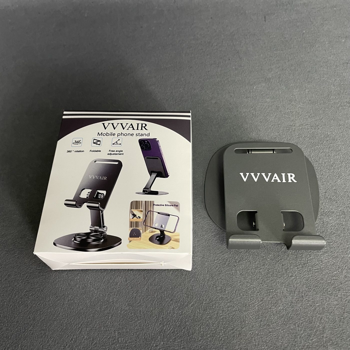 The packaging box facing the camera with the Space Gray stand laid flat beside it