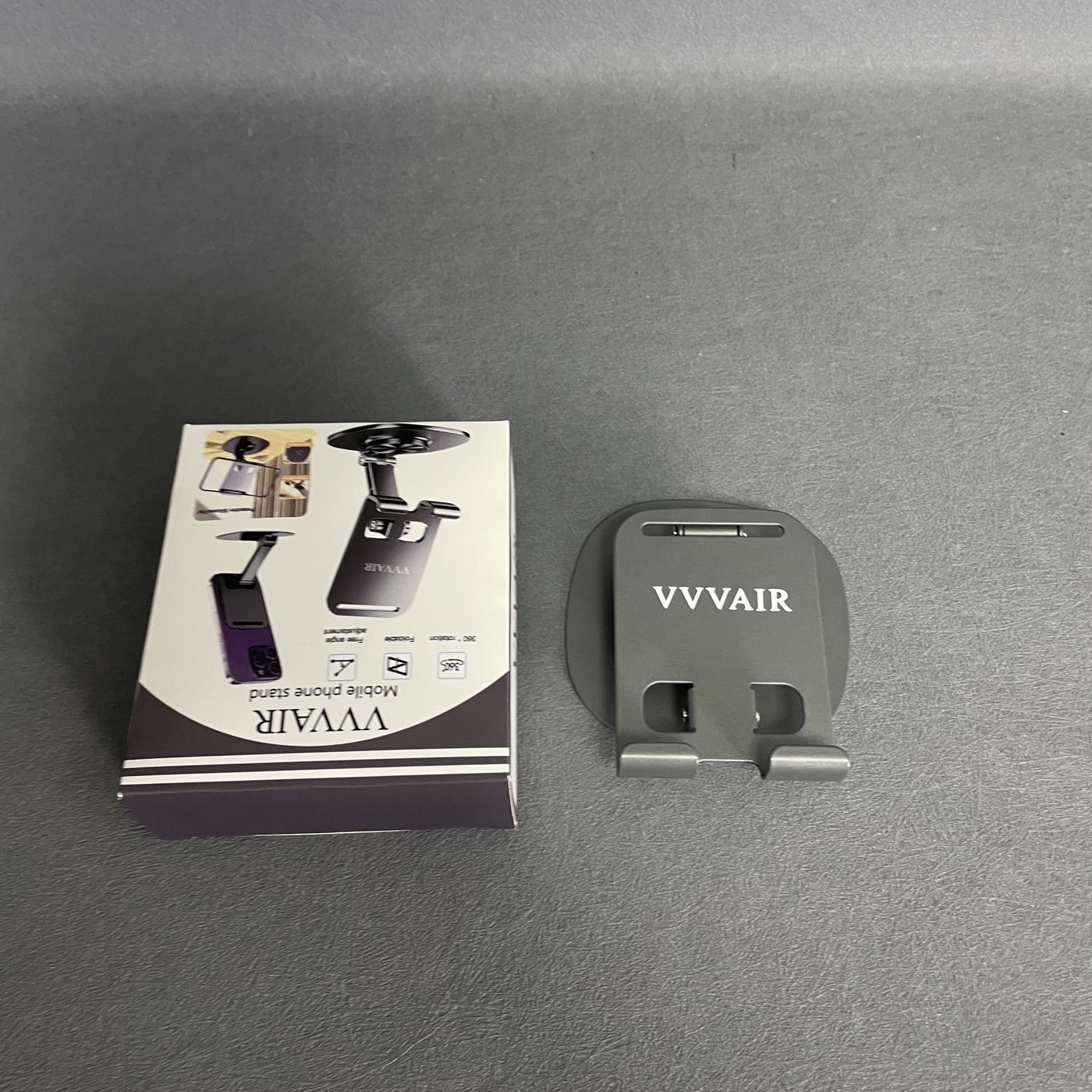 The box and the Space Gray stand resting flat on the surface, photographed from a higher angle